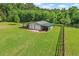 Large outbuilding featuring two garage doors and an attached carport, perfect for storage and hobbies at 24 Fossetts Nw Cv, Cartersville, GA 30121