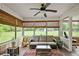 Relaxing screened-in porch with comfortable seating, offering views of the outdoor landscape at 24 Fossetts Nw Cv, Cartersville, GA 30121