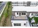 Aerial view of townhome roofs and street showing the private outdoor terrace space at 1030 Burnside Nw Pl, Atlanta, GA 30318