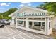 Charming exterior of Henri's Bakery & Cafe features lots of seating and parking spots at 1030 Burnside Nw Pl, Atlanta, GA 30318