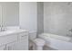 Well-lit bathroom with tiled floors and shower and granite countertops at 1030 Burnside Nw Pl, Atlanta, GA 30318