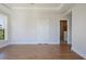 Bright bedroom showcasing hardwood floors, a tray ceiling, and an ensuite bathroom at 1030 Burnside Nw Pl, Atlanta, GA 30318