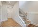 Bright entryway with hardwood floors and a staircase featuring black iron railings at 1030 Burnside Nw Pl, Atlanta, GA 30318