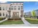 Modern townhome with landscaped front yard and sidewalk leading to the entrance at 1030 Burnside Nw Pl, Atlanta, GA 30318