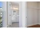 Bright hallway view showing an open closet and a bathroom with granite counters at 1030 Burnside Nw Pl, Atlanta, GA 30318