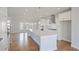 A spacious kitchen with stainless steel appliances, white cabinets, hardwood floors, and a large island at 1030 Burnside Nw Pl, Atlanta, GA 30318