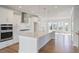 Bright, open kitchen featuring a large island, stainless steel appliances, and hardwood floors at 1030 Burnside Nw Pl, Atlanta, GA 30318
