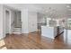 Open-concept kitchen and living space with hardwood floors, modern appliances, and a large kitchen island at 1030 Burnside Nw Pl, Atlanta, GA 30318