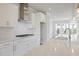 Modern kitchen with white cabinets, stainless steel hood, and a spacious countertop at 1030 Burnside Nw Pl, Atlanta, GA 30318