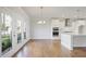 Open concept kitchen and dining area with hardwood floors, modern lighting, and access to a balcony at 1030 Burnside Nw Pl, Atlanta, GA 30318