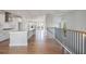Open-concept living space with hardwood floors, kitchen, and staircase with black railings at 1030 Burnside Nw Pl, Atlanta, GA 30318
