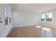 Bright living room featuring hardwood floors and large windows for natural light at 1030 Burnside Nw Pl, Atlanta, GA 30318