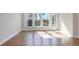 Bright living room with hardwood floors, large windows, and a door leading to the outside at 1030 Burnside Nw Pl, Atlanta, GA 30318