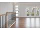 Upstairs landing featuring modern railing and view into a bright, open living space at 1030 Burnside Nw Pl, Atlanta, GA 30318