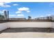 Rooftop deck overlooking surrounding buildings and neighborhood in the distance at 1030 Burnside Nw Pl, Atlanta, GA 30318