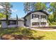 Two-story home with painted brick, black shutters, a concrete walkway, and manicured landscaping at 2158 Oregon Ct, Decatur, GA 30032