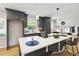 Modern kitchen featuring an island with counter seating, pendant lights, and sleek cabinetry at 2158 Oregon Ct, Decatur, GA 30032