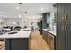 Open kitchen with island seating, stainless steel appliances, and an adjacent dining area at 2158 Oregon Ct, Decatur, GA 30032