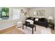 Cozy living room featuring hardwood floors, ample seating, and natural light from large windows at 2158 Oregon Ct, Decatur, GA 30032
