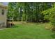 Level backyard featuring well-maintained lawn, mature trees, and a view of the home's rear exterior at 3845 Pilgrim Mill Rd, Cumming, GA 30041