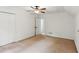 Spacious empty bedroom with neutral carpet, a ceiling fan and two closets at 3845 Pilgrim Mill Rd, Cumming, GA 30041
