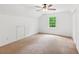 Empty bedroom with neutral carpet, a window, and a ceiling fan at 3845 Pilgrim Mill Rd, Cumming, GA 30041