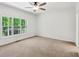 Carpeted bedroom featuring large windows, white walls, and a ceiling fan at 3845 Pilgrim Mill Rd, Cumming, GA 30041