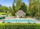 Community pool with a privacy fence and a covered area that offers tables and chairs for residents at 3845 Pilgrim Mill Rd, Cumming, GA 30041