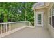 Back deck, with white railing, outside door, and natural view of green trees at 3845 Pilgrim Mill Rd, Cumming, GA 30041