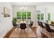 Elegant dining area with large windows, a stylish table, and counter seating at 3845 Pilgrim Mill Rd, Cumming, GA 30041