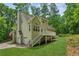 Back of house with a view of the deck, yard, and garage entrance, and American flag at 3845 Pilgrim Mill Rd, Cumming, GA 30041