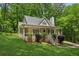 Cozy home featuring a covered porch, mature trees, and a meticulously manicured front yard at 3845 Pilgrim Mill Rd, Cumming, GA 30041