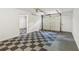 Spacious two-car garage with black-and-white checkered flooring and overhead lighting at 3845 Pilgrim Mill Rd, Cumming, GA 30041
