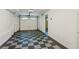 Two-car garage featuring black and white checkered flooring and bright lighting with easy access at 3845 Pilgrim Mill Rd, Cumming, GA 30041