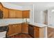 Well-lit kitchen showcasing wood cabinets, stainless steel appliances, and hardwood flooring at 3845 Pilgrim Mill Rd, Cumming, GA 30041
