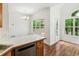 Bright kitchen nook area featuring hardwood floors, large windows, and a door to the backyard at 3845 Pilgrim Mill Rd, Cumming, GA 30041