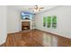 Cozy living room features a stone fireplace, a large window, and hardwood flooring at 3845 Pilgrim Mill Rd, Cumming, GA 30041