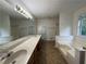 Large bathroom with dual sinks, garden tub, and separate shower at 1100 Whistle Dr, Austell, GA 30106