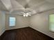 Spacious bedroom featuring dark wood floors, tray ceiling and modern fan at 1100 Whistle Dr, Austell, GA 30106