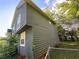 Home's siding showing green vinyl siding, fenced yard, and lots of tree cover at 1100 Whistle Dr, Austell, GA 30106