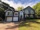 Two-story home with a well-maintained yard and a two-car garage in a suburban neighborhood at 1100 Whistle Dr, Austell, GA 30106