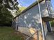 Rear view of home with blue vinyl siding, fenced-in yard, and side entry garage at 1100 Whistle Dr, Austell, GA 30106