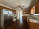 Traditional kitchen with stainless steel refrigerator, wooden cabinets, and hardwood floors at 1100 Whistle Dr, Austell, GA 30106