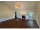 Spacious living room featuring hardwood floors, a fireplace, and a ceiling fan at 1100 Whistle Dr, Austell, GA 30106