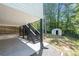 Backyard with concrete patio, stairs, shed and lush green landscaping and wooden fence at 1505 Cedar Bluff Trl, Marietta, GA 30062
