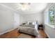 Charming bedroom features hardwood floors, a ceiling fan, and a sunlit window at 1505 Cedar Bluff Trl, Marietta, GA 30062