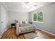 Bright bedroom with hardwood floors, a ceiling fan, and a sunlit window with green views at 1505 Cedar Bluff Trl, Marietta, GA 30062
