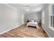 Bright bedroom featuring hardwood floors, neutral paint and a charming ceiling fan with light at 1505 Cedar Bluff Trl, Marietta, GA 30062