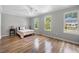 Spacious bedroom with hardwood floors, a ceiling fan, and large windows with backyard views at 1505 Cedar Bluff Trl, Marietta, GA 30062