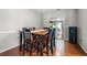 Cozy dining room with hardwood floors, a modern table with chairs, and sliding glass doors at 1505 Cedar Bluff Trl, Marietta, GA 30062